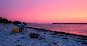 Image of Ben Wurst dials in his camera to take a photograph of an outstanding Barnegat Bay sunrise.