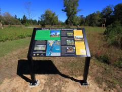 Image of Large interpretive sign at Ballanger Creek informs visitors about the habitat enhancement performed on site, value of habitat management, and the wildlife that occur in the area