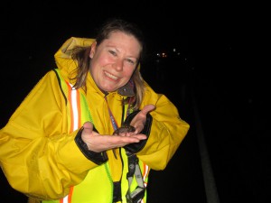 Karen Ruzycki gives a salamander a lift.  Photo: M. Hall